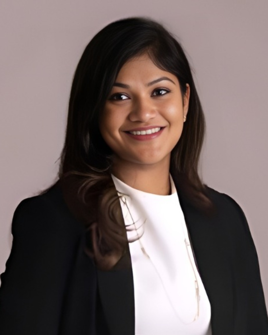 WhatsApp Image 2026-07-10 at 164953 | Dr Swetha Cosmodermcentre Professional headshot of a woman in a white blouse and black blazer, smiling against a neutral backdrop